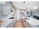 Bright open concept kitchen features white cabinets, stainless appliances, and marble countertops at 9930 Cask Way, Huntersville, NC 28078