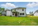 Spacious backyard with well-maintained lawn and a covered patio, ideal for outdoor enjoyment at 9957 Cask Way, Huntersville, NC 28078