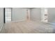 Large bedroom with neutral paint and carpet and entrances to the bathroom and closet at 9957 Cask Way, Huntersville, NC 28078