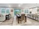 Dining area with wood floors, white walls and trim, with an open-concept kitchen at 9957 Cask Way, Huntersville, NC 28078