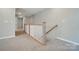 Upstairs hallway featuring neutral paint, carpet, and railing at 9957 Cask Way, Huntersville, NC 28078