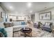 Open-concept living room with a large sofa, stylish decor, and hardwood floors at 9957 Cask Way, Huntersville, NC 28078
