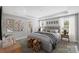 Beautiful main bedroom with a tray ceiling, decorative art, and a glimpse of the bathroom at 9957 Cask Way, Huntersville, NC 28078