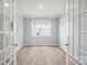 Spacious room with wood floors, bright window, and double doors at 9957 Cask Way, Huntersville, NC 28078