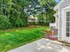 Backyard featuring well-maintained grass, greenery, and a patio space at 10063 Reindeer Way Ln, Charlotte, NC 28216