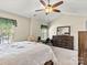 Comfortable bedroom with vaulted ceiling, large dresser, and neutral carpet and decor at 10063 Reindeer Way Ln, Charlotte, NC 28216