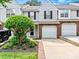 Charming townhome with attached garage, manicured landscaping, and neutral siding for inviting curb appeal at 10063 Reindeer Way Ln, Charlotte, NC 28216