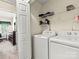 Functional laundry area equipped with a washer, dryer, and shelving for storage at 10063 Reindeer Way Ln, Charlotte, NC 28216
