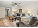 Inviting living room with wood floors, ceiling fan, and comfortable gray sofa and love seat at 10063 Reindeer Way Ln, Charlotte, NC 28216