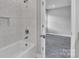 Bathroom featuring tiled shower and tub combination with modern fixtures at 1102 Grady St, Salisbury, NC 28144
