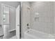 Bathroom featuring tiled shower and tub combination with modern fixtures at 1102 Grady St, Salisbury, NC 28144