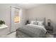 Neutral bedroom features soft gray quilted bedding, lamps, and a large window at 1102 Grady St, Salisbury, NC 28144