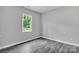 Bright bedroom featuring hardwood flooring and natural light streaming through a window with a view of lush greenery at 1102 Grady St, Salisbury, NC 28144