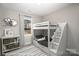 bedroom with a bunk bed with steps, bookshelf, and view from the window at 1102 Grady St, Salisbury, NC 28144