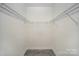 Empty walk-in closet features wooden floors, bright white paint, and metal racks at 1102 Grady St, Salisbury, NC 28144