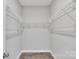 Walk-in closet featuring simple white shelving and neutral paint at 1102 Grady St, Salisbury, NC 28144
