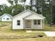 Charming white home with a cozy front porch and well manicured lawn at 1102 Grady St, Salisbury, NC 28144