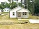 Charming white home with a cozy front porch and well manicured lawn at 1102 Grady St, Salisbury, NC 28144