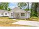 Charming single-Gathering home with a well-manicured lawn and inviting front porch and a concrete driveway at 1102 Grady St, Salisbury, NC 28144