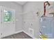 Functional laundry room featuring appliances hookups, storage shelf, and an exterior door for convenience at 1102 Grady St, Salisbury, NC 28144