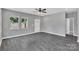 Open-concept living room featuring luxury vinyl plank floors, a ceiling fan, and natural light at 1102 Grady St, Salisbury, NC 28144