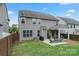 Backyard view shows a patio with seating and dining areas and green lawn at 1306 San Gabriel Ave, Charlotte, NC 28214