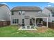 Backyard view shows a patio with seating and dining areas and green lawn at 1306 San Gabriel Ave, Charlotte, NC 28214
