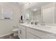 Modern bathroom featuring double sink vanity, a window, and a shower tub with white cabinets and neutral walls at 1306 San Gabriel Ave, Charlotte, NC 28214