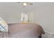 Comfortable bedroom view shows a door to the hallway, and a ceiling fan at 1306 San Gabriel Ave, Charlotte, NC 28214