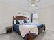 Cozy bedroom with a dark wood bed frame, side table and large window with blue curtains and neutral walls at 1306 San Gabriel Ave, Charlotte, NC 28214