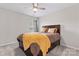 Comfortable bedroom features a ceiling fan, soft carpet, and a bed with storage drawers at 1306 San Gabriel Ave, Charlotte, NC 28214