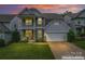 Charming two-story home with a welcoming front porch and attached two-car garage at 1306 San Gabriel Ave, Charlotte, NC 28214