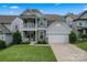Charming two-story home with a welcoming front porch and attached two-car garage at 1306 San Gabriel Ave, Charlotte, NC 28214