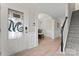Bright foyer with hardwood floors, decorative archway, and staircase at 1306 San Gabriel Ave, Charlotte, NC 28214