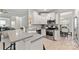 Bright kitchen featuring white cabinets, subway tile backsplash, and stainless steel appliances at 1306 San Gabriel Ave, Charlotte, NC 28214