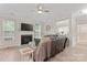 Spacious living room with a fireplace, ceiling fan, and comfortable seating area at 1306 San Gabriel Ave, Charlotte, NC 28214