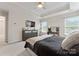 Comfortable main bedroom features tray ceilings, a ceiling fan, a wall-mounted TV, and lots of natural light at 1306 San Gabriel Ave, Charlotte, NC 28214