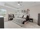Spacious main bedroom with large window and tray ceiling, featuring a king bed and matching furniture at 1306 San Gabriel Ave, Charlotte, NC 28214