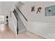 Carpeted staircase with modern railing and decorative wall paneling at 1306 San Gabriel Ave, Charlotte, NC 28214
