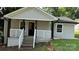 Charming front of house featuring a cozy porch with black posts and white railings at 148 Forest Heights Dr, Mcadenville, NC 28101