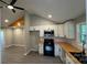 An airy kitchen featuring white cabinetry, modern appliances, wood countertops, and gray flooring at 148 Forest Heights Dr, Mcadenville, NC 28101