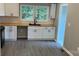 A kitchen featuring white cabinets, wood countertops, a subway tile backsplash, and a black sink at 148 Forest Heights Dr, Mcadenville, NC 28101