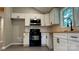 An eat-in kitchen features white cabinets and stainless steel appliances and a black stove at 148 Forest Heights Dr, Mcadenville, NC 28101