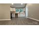 Eat-in kitchen with white cabinets, butcher block countertops, and grey laminate flooring at 148 Forest Heights Dr, Mcadenville, NC 28101