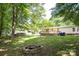 Spacious backyard featuring a fire pit, large deck, and lush lawn perfect for entertaining at 155 Springdale Acres Dr, Mooresville, NC 28115