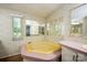 Bathroom featuring large tub, large mirrors, pink countertop, and a window at 155 Springdale Acres Dr, Mooresville, NC 28115
