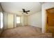 Cozy bedroom with neutral wallpaper and carpet, ceiling fan and doors at 155 Springdale Acres Dr, Mooresville, NC 28115