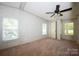 Bedroom with a ceiling fan, two windows, neutral carpet and wallpaper at 155 Springdale Acres Dr, Mooresville, NC 28115
