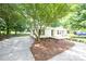Charming one-story home with a well-maintained lawn and driveway, nestled among mature trees at 155 Springdale Acres Dr, Mooresville, NC 28115