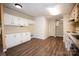 A bright kitchen with white cabinets and stainless steel appliances featuring wood-look floors at 155 Springdale Acres Dr, Mooresville, NC 28115
